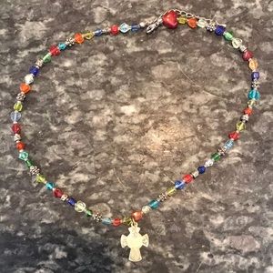 Multicolored bead necklace with cross pendant.